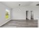 Bright living room with stylish gray wood floors, neutral walls, and modern lighting at 16697 Sw 30 Avenue Rd, Ocala, FL 34473