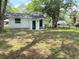 Back of a white home with a black fence and a small yard. Lawn needs some TLC at 1705 Nw 18Th Ave, Ocala, FL 34475