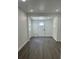 Entryway featuring grey vinyl floors, a white front door and ample natural light at 1705 Nw 18Th Ave, Ocala, FL 34475