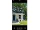 Beautifully landscaped white home with a dark blue door and well-manicured yard at 1705 Nw 18Th Ave, Ocala, FL 34475
