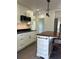 Modern white kitchen with stainless steel appliances and a kitchen island at 1705 Nw 18Th Ave, Ocala, FL 34475