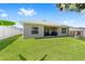 Spacious backyard featuring lush green grass and a covered patio, perfect for outdoor entertaining and enjoying the outdoors at 181 Nw 45Th Loop, Ocala, FL 34475