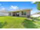 Landscaped backyard with a covered patio, offering a peaceful outdoor space with room for relaxation and entertainment at 181 Nw 45Th Loop, Ocala, FL 34475
