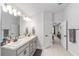 Bright bathroom featuring double sinks, granite countertops, and neutral finishes at 181 Nw 45Th Loop, Ocala, FL 34475