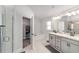 Bathroom with double sink vanity, soaking tub, and glass-enclosed shower at 181 Nw 45Th Loop, Ocala, FL 34475