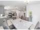 Open-concept dining area adjacent to a modern kitchen with stainless steel appliances and granite countertops at 181 Nw 45Th Loop, Ocala, FL 34475