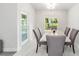 Elegant dining room featuring a marble table, comfortable chairs, and a view of the outdoors at 181 Nw 45Th Loop, Ocala, FL 34475