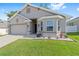 Attractive single-story home featuring a landscaped front yard, garage, and inviting entrance at 181 Nw 45Th Loop, Ocala, FL 34475