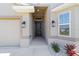Inviting front entryway with a sleek black door, manicured landscaping, and stylish exterior lighting at 181 Nw 45Th Loop, Ocala, FL 34475