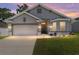Charming single-story home showcasing a well-manicured lawn and inviting front entrance at dusk at 181 Nw 45Th Loop, Ocala, FL 34475