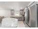 Bright kitchen featuring stainless steel appliances, gray cabinets, and granite countertops at 181 Nw 45Th Loop, Ocala, FL 34475