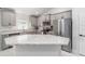 Modern kitchen with granite countertops, stainless steel appliances, and gray cabinets at 181 Nw 45Th Loop, Ocala, FL 34475