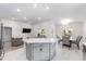 Open-concept kitchen with center island, flowing into the dining and living areas at 181 Nw 45Th Loop, Ocala, FL 34475