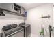 Laundry room with gray washer and dryer units and cleaning supply storage at 181 Nw 45Th Loop, Ocala, FL 34475