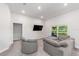 Cozy living area with a comfortable gray sectional, a large window, and recessed lighting at 181 Nw 45Th Loop, Ocala, FL 34475