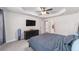 Bright main bedroom featuring a tray ceiling, ceiling fan, and neutral decor at 181 Nw 45Th Loop, Ocala, FL 34475