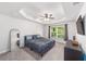 Spacious main bedroom with tray ceiling, large window, and carpeted floor at 181 Nw 45Th Loop, Ocala, FL 34475