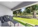 Outdoor patio showcasing comfortable seating and picturesque views of the surrounding green landscape and mature trees at 181 Nw 45Th Loop, Ocala, FL 34475