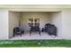 Covered patio with outdoor seating, perfect for relaxing and enjoying the fresh air with room for an outdoor grill at 181 Nw 45Th Loop, Ocala, FL 34475