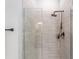 Modern shower featuring gray tile, glass enclosure, and sleek fixtures at 181 Nw 45Th Loop, Ocala, FL 34475