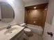 Bathroom with white vanity, updated fixtures, tile shower, and round mirror at 1910 Sw 34Th Ct, Ocala, FL 34474