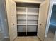 Closet with shelving and white louvered bi-fold doors at 1910 Sw 34Th Ct, Ocala, FL 34474