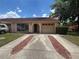 Inviting single-story home with tile roof, attached garage, tidy landscaping and attractive front yard at 1910 Sw 34Th Ct, Ocala, FL 34474