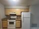 Well-lit kitchen featuring white appliances and wooden cabinets and granite countertops at 1910 Sw 34Th Ct, Ocala, FL 34474