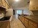 Functional kitchen featuring granite countertops, wooden cabinets and white appliances at 1910 Sw 34Th Ct, Ocala, FL 34474