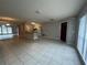 Open-concept living and dining area with neutral tile flooring and lots of natural light at 1910 Sw 34Th Ct, Ocala, FL 34474