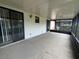 Covered patio featuring sliding glass doors, a small window, a light fixture, and a concrete floor at 1910 Sw 34Th Ct, Ocala, FL 34474