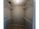 A spacious walk-in closet with shelving on each wall for optimal storage at 1910 Sw 34Th Ct, Ocala, FL 34474