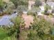 Aerial view of a neighborhood showcasing well-maintained homes with lush landscaping and mature trees at 19586 Sw 84Th Pl, Dunnellon, FL 34432