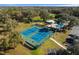 Aerial view showcasing the community tennis courts, pool and amenities at 19586 Sw 84Th Pl, Dunnellon, FL 34432