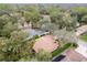 An aerial view shows a home with a brown roof and well-maintained surroundings, with lush greenery and trees at 19586 Sw 84Th Pl, Dunnellon, FL 34432