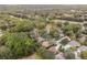 An aerial view of homes nestled among lush green trees, showcasing a tranquil and secluded neighborhood at 19586 Sw 84Th Pl, Dunnellon, FL 34432