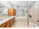 Bathroom features a large soaking tub, double vanity, and a glass-enclosed shower at 19586 Sw 84Th Pl, Dunnellon, FL 34432