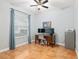 Bedroom with ceiling fan, tile floors, and space for a home office setup at 19586 Sw 84Th Pl, Dunnellon, FL 34432