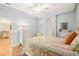 Light blue bedroom with floral bedspread, neutral furniture, and arched doorway at 19586 Sw 84Th Pl, Dunnellon, FL 34432