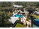 Aerial shot of community pool and tennis courts surrounded by trees at 19586 Sw 84Th Pl, Dunnellon, FL 34432