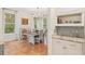 Bright dining area featuring a chandelier and serene window views for enjoyable gatherings at 19586 Sw 84Th Pl, Dunnellon, FL 34432