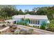Inviting community building showcasing a covered entrance, neat landscaping and plenty of greenery at 19586 Sw 84Th Pl, Dunnellon, FL 34432