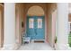 Close-up of the home's beautiful blue double doors under a columned archway at 19586 Sw 84Th Pl, Dunnellon, FL 34432
