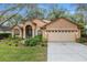 Inviting single-story home featuring a well-maintained front lawn and attached two-car garage at 19586 Sw 84Th Pl, Dunnellon, FL 34432