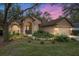 Beautiful home exterior highlighting lush landscaping, a well-maintained lawn, and inviting curb appeal at 19586 Sw 84Th Pl, Dunnellon, FL 34432