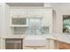 The kitchen features a farmhouse sink, stainless steel dishwasher, and decorative backsplash at 19586 Sw 84Th Pl, Dunnellon, FL 34432