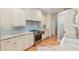 Kitchen boasts granite countertops, stainless steel appliances, and white cabinetry, with a pantry door at 19586 Sw 84Th Pl, Dunnellon, FL 34432