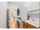 Functional laundry area with stacked washer and dryer, sink, and storage, conveniently located near the kitchen at 19586 Sw 84Th Pl, Dunnellon, FL 34432