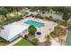 Aerial view of community pool surrounded by lounge chairs and landscaping, perfect for relaxation and community fun at 19586 Sw 84Th Pl, Dunnellon, FL 34432