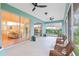 Expansive screened-in porch providing ample space with views of the living area and lush greenery at 19586 Sw 84Th Pl, Dunnellon, FL 34432